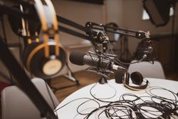 Podcast studio with microphone in foreground